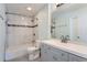 Modern bathroom with a shower-tub combination and gray vanity with double sinks at 2504 S Victor St # E, Aurora, CO 80014