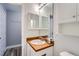 Bright bathroom with a large mirror, a functional vanity, and a toilet at 2504 S Victor St # E, Aurora, CO 80014