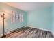 This cozy bedroom features lovely flooring, a window with white blinds, and light-blue painted walls at 2504 S Victor St # E, Aurora, CO 80014