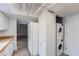 Kitchen with a white washer and dryer and stainless appliances at 2504 S Victor St # E, Aurora, CO 80014