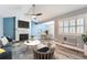 Inviting living room with fireplace, ceiling fan, and view of the dining area at 2504 S Victor St # E, Aurora, CO 80014
