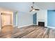 Bright living room with sleek hardwood floors and a charming brick fireplace at 2504 S Victor St # E, Aurora, CO 80014