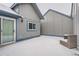 Exterior patio featuring wood siding, with blue trim, and furniture covered in fresh snowfall at 2504 S Victor St # E, Aurora, CO 80014
