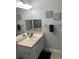 Bathroom vanity with mirror and decorative towels, complemented by gray paint and neutral accents at 5755 N Genoa Way # 14-105, Aurora, CO 80019