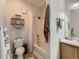 Bathroom featuring a shower-tub combo, toilet, and a wooden vanity with sink at 5755 N Genoa Way # 14-105, Aurora, CO 80019
