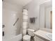 Well-lit bathroom featuring a bathtub, shower with striped curtain, toilet, and sink at 5755 N Genoa Way # 14-105, Aurora, CO 80019