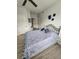 Bright bedroom featuring a metal bedframe, blue bedding, and luxury vinyl flooring at 5755 N Genoa Way # 14-105, Aurora, CO 80019