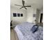 Bedroom features a modern ceiling fan, light gray walls and neutral-colored laminate floors at 5755 N Genoa Way # 14-105, Aurora, CO 80019