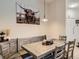 Stylish dining room featuring rustic wood table with booth and picture of cow at 5755 N Genoa Way # 14-105, Aurora, CO 80019