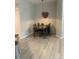 Corner dining room area features a gray table with chairs and a decorative heart hanging on the wall at 5755 N Genoa Way # 14-105, Aurora, CO 80019
