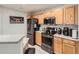Efficient kitchen featuring stainless steel appliances, wood cabinets, and sleek countertops at 5755 N Genoa Way # 14-105, Aurora, CO 80019
