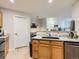Well-lit kitchen featuring granite counters, a large sink, and stainless-steel dishwasher at 5755 N Genoa Way # 14-105, Aurora, CO 80019