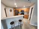 Bright kitchen features stainless steel appliances, wood cabinetry, and a breakfast bar with stool seating at 5755 N Genoa Way # 14-105, Aurora, CO 80019
