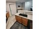 Kitchen features a stainless steel sink, wood cabinetry, and modern appliances at 5755 N Genoa Way # 14-105, Aurora, CO 80019