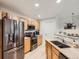 Modern kitchen with stainless steel appliances, granite countertops, and wooden cabinets at 5755 N Genoa Way # 14-105, Aurora, CO 80019