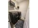 Convenient laundry room equipped with a modern, front-loading washer and dryer at 5755 N Genoa Way # 14-105, Aurora, CO 80019