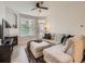 Cozy living room featuring a plush sofa, fireplace, and abundant natural light from large windows at 5755 N Genoa Way # 14-105, Aurora, CO 80019