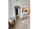 Living area with breakfast bar, leading into a hallway and bathroom at 5755 N Genoa Way # 14-105, Aurora, CO 80019