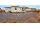 Manicured backyard with stone landscaping, deck, and covered patio at 4063 Castle Vista Dr, Castle Rock, CO 80104