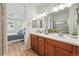 Bright bathroom featuring a double sink vanity, and a glass-enclosed shower at 4063 Castle Vista Dr, Castle Rock, CO 80104
