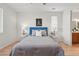 Cozy bedroom with modern decor featuring a blue headboard, two side tables, and a soft gray blanket at 4063 Castle Vista Dr, Castle Rock, CO 80104