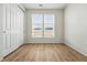 Bedroom with wood-look floors, window, and closet at 4063 Castle Vista Dr, Castle Rock, CO 80104