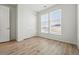 This bedroom offers wood-look floors, window, and closet at 4063 Castle Vista Dr, Castle Rock, CO 80104