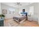 Bright bedroom with a blue upholstered headboard and stylish decor, enhanced by natural light from large windows at 4063 Castle Vista Dr, Castle Rock, CO 80104