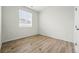 Bedroom features vinyl wood flooring, a window and white trim at 4063 Castle Vista Dr, Castle Rock, CO 80104