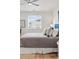Comfortable bedroom with a neutral color palette, a large window, and stylish throw pillows on the bed at 4063 Castle Vista Dr, Castle Rock, CO 80104
