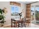Cozy dining area features a wooden table, stylish chairs, and a window with natural light at 4063 Castle Vista Dr, Castle Rock, CO 80104