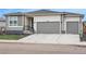 Charming single-story home with a two-car garage and well-manicured front lawn, showcasing modern curb appeal at 4063 Castle Vista Dr, Castle Rock, CO 80104