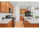 Modern kitchen with stainless steel appliances, quartz countertops, and white subway tile backsplash at 4063 Castle Vista Dr, Castle Rock, CO 80104