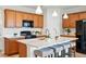 Bright kitchen boasts a spacious island with seating, stainless steel appliances, and ample cabinet space at 4063 Castle Vista Dr, Castle Rock, CO 80104