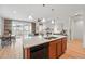 Open concept kitchen with island seating flows into the dining area and living room with fireplace at 4063 Castle Vista Dr, Castle Rock, CO 80104