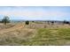 An expansive field with a dirt road and scenic mountain views in the distance at 4063 Castle Vista Dr, Castle Rock, CO 80104
