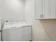 Laundry room featuring a washer and dryer set with white cabinets at 4063 Castle Vista Dr, Castle Rock, CO 80104