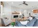 Open living room area with fireplace, comfortable seating, and view into the kitchen at 4063 Castle Vista Dr, Castle Rock, CO 80104