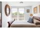 Bright bedroom featuring large windows and elegant wooden furniture at 879 Delaware St, Denver, CO 80204