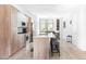 Spacious kitchen featuring modern cabinetry, a large island, stainless steel appliances and hardwood floors at 879 Delaware St, Denver, CO 80204