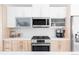 Modern kitchen featuring stainless steel appliances, stylish cabinets, and ample counter space at 879 Delaware St, Denver, CO 80204