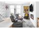 Comfortable living room with cozy armchairs, fireplace, and ample natural light at 879 Delaware St, Denver, CO 80204