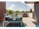 Comfortable dining area with grill on spacious outdoor patio with a view, perfect for entertaining at 879 Delaware St, Denver, CO 80204