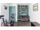 Inviting workout room with exercise bike, decorative shelving, and a soothing color palette at 879 Delaware St, Denver, CO 80204