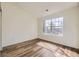 Bedroom with large window, wood-look flooring, and ample natural light at 12288 W Dorado Pl # 301, Littleton, CO 80127