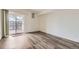 Bright bedroom with wood floors, balcony access, and neutral paint at 12288 W Dorado Pl # 301, Littleton, CO 80127