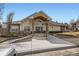 Exterior of a clubhouse with stone accents and a covered entrance at 12288 W Dorado Pl # 301, Littleton, CO 80127