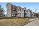 Charming condo complex featuring multi-level balconies, stone accents, and manicured landscaping at 12288 W Dorado Pl # 301, Littleton, CO 80127