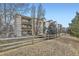 Multi-story condo building with balconies and lush landscaping at 12288 W Dorado Pl # 301, Littleton, CO 80127