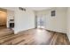 Open living room with fireplace, balcony access, and wood-look floors at 12288 W Dorado Pl # 301, Littleton, CO 80127